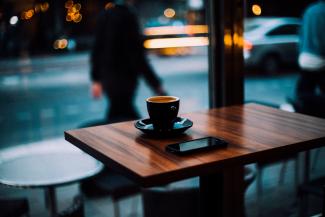 table with coffee and phone in a cafe
