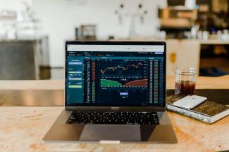 laptop showing graphs of a generic stock over time