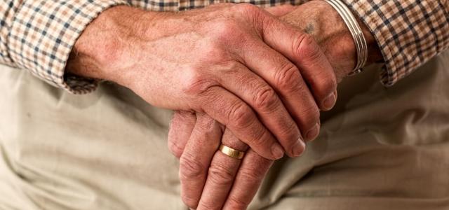 elderly hands on a cane