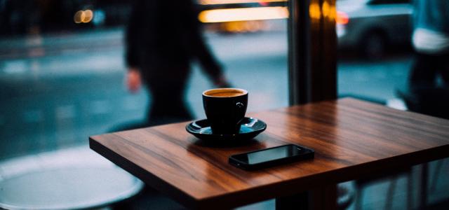 table with coffee and phone in a cafe 