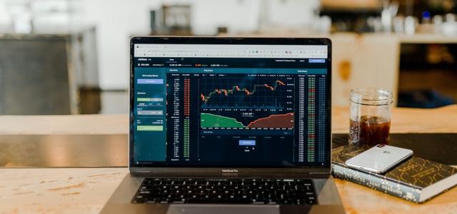 laptop showing graphs of a generic stock over time